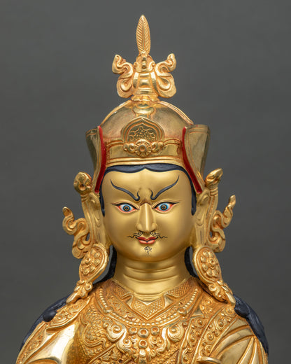 Close up Guru Rinpoche statue face copper gold painted sacred art