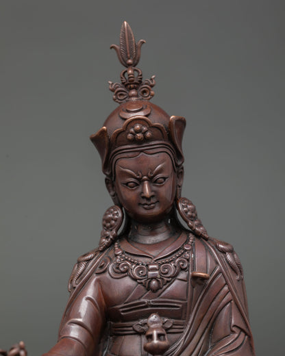 Close up Guru Rinpoche statue showing detailed face traditional iconography and Himalayan Buddhist craftsmanship