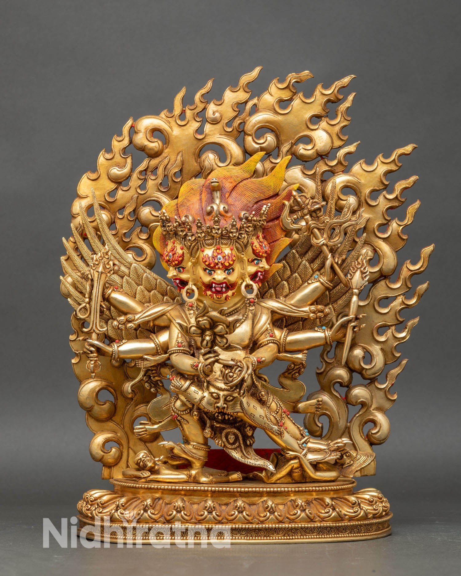 Close up of hayagriva statue showing three faces and sacred ritual attributes
