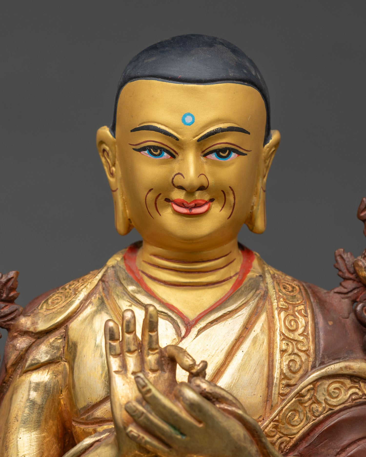 Close up Je Tsongkhapa statue hand painted details Dharmachakra Mudra