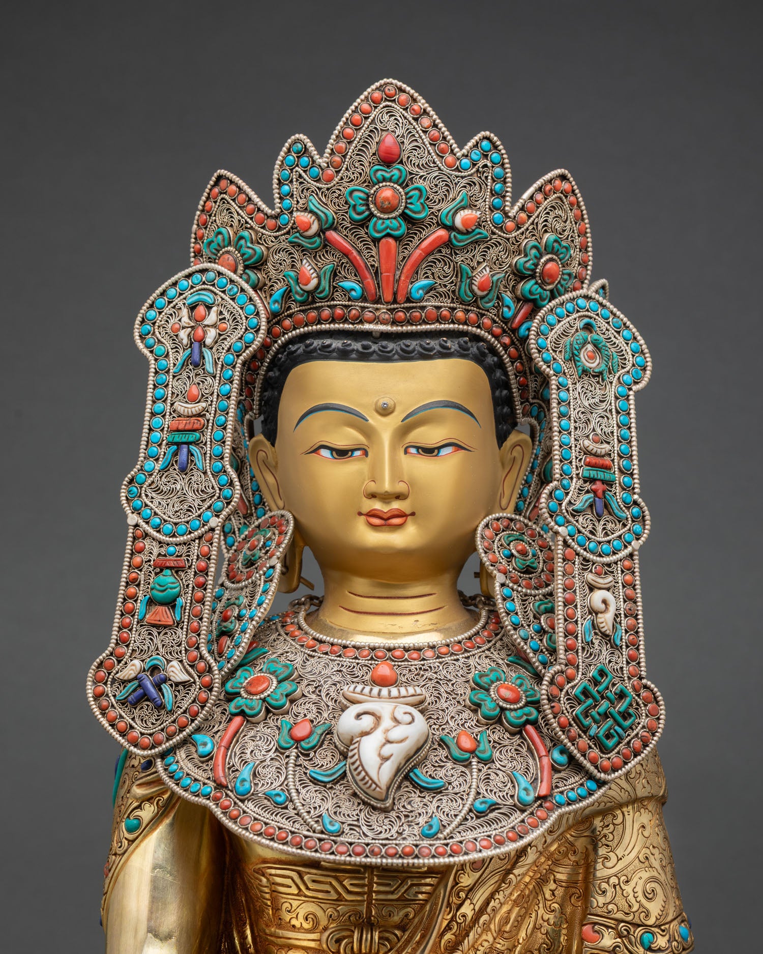 Close up Jowo Rinpoche Buddha face detail hand painted golden finish semi precious inlaid floral ornaments, sacred Buddhist art
