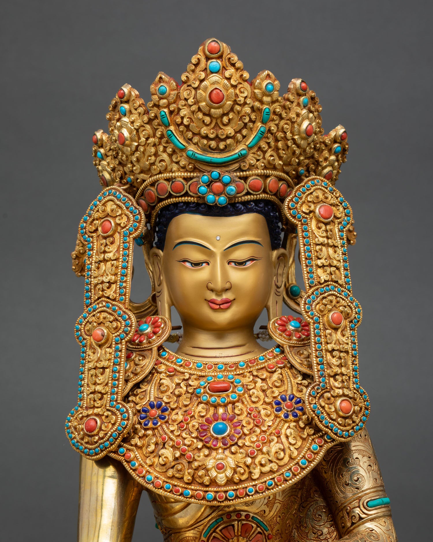 Close up Jowo Rinpoche statue gold finished face serene expression semi precious stones intricate floral carvings lost wax casting Nepal