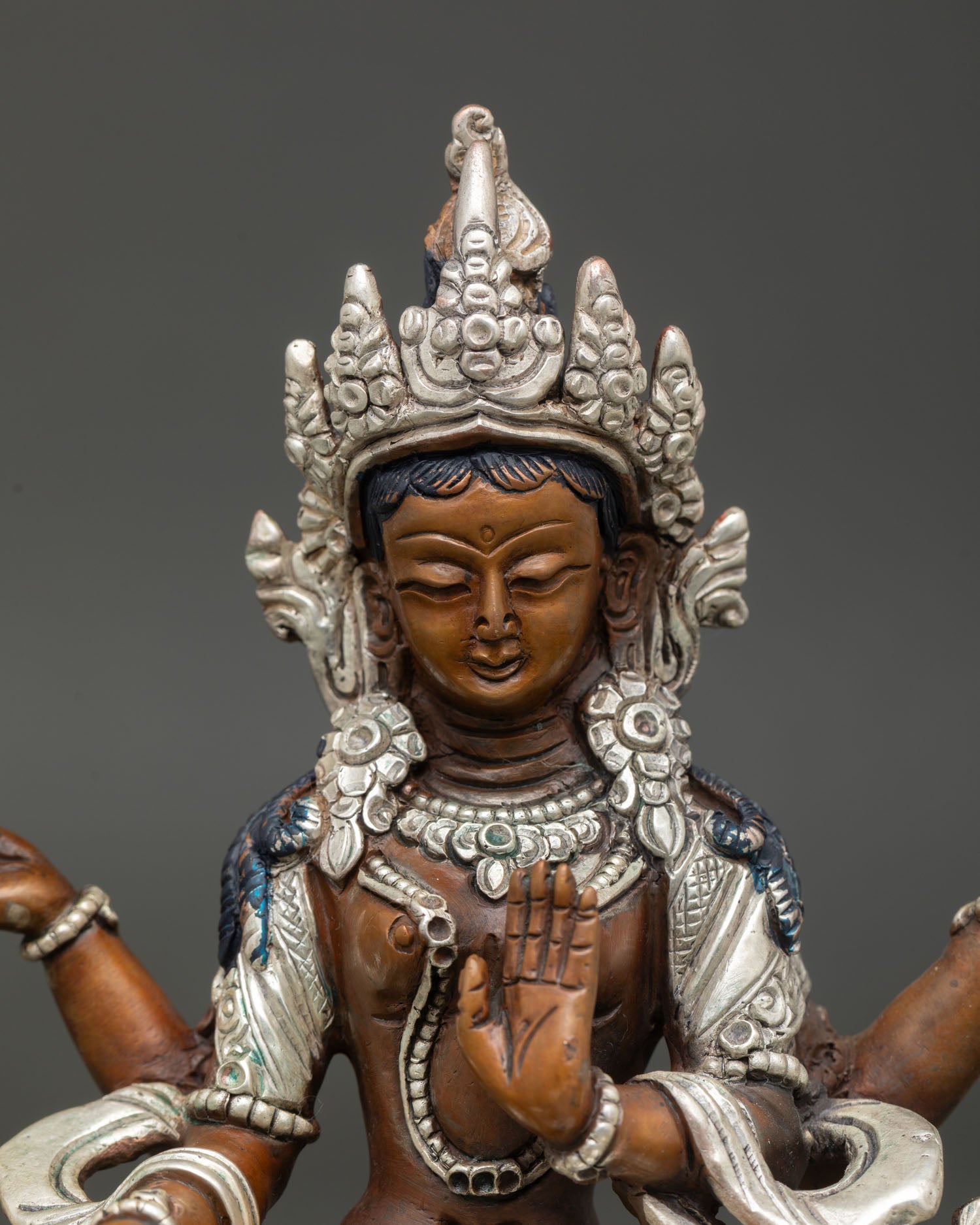 Close up Lakshmi statue showing four hands lotus flower pot of gold varada mudra Newari artisan craftsmanship