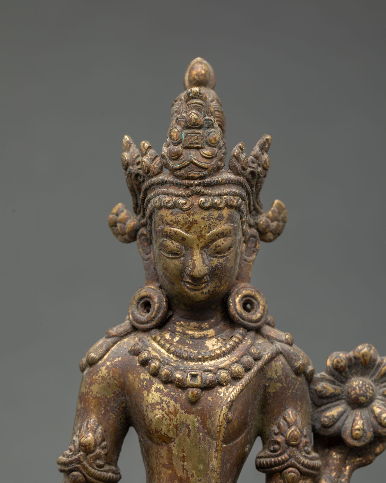 Close up Lokeshvara face detail Padmapani statue gold gilded copper Himalayan art Newari craftsmanship Buddhist compassion deity tribhanga posture