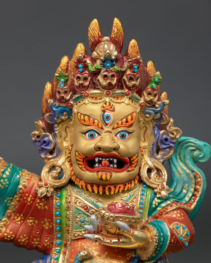 Close up view of Mahakala Bernagchen face with gold painted details semi precious stone decoration and Himalayan craftsmanship