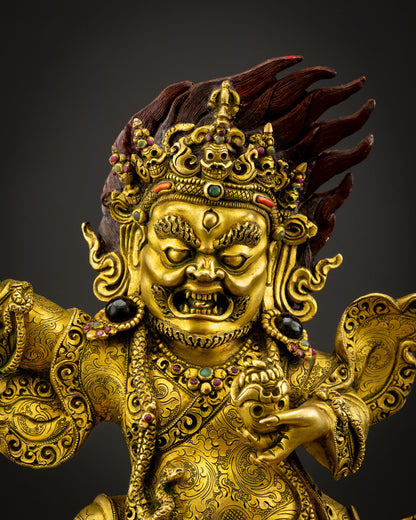 Close up Mahakala Bernagchen gold painted face Himalayan Buddhist sculpture