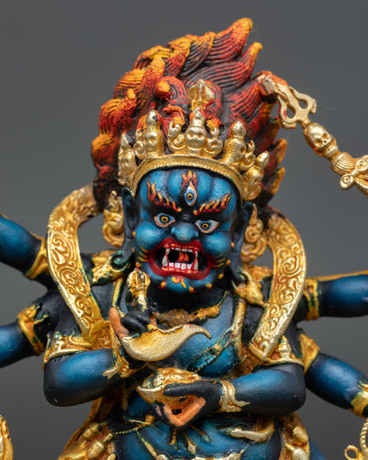 Close up Mahakala fierce face with intense expression crushing subdued figure and symbol of victory over ignorance