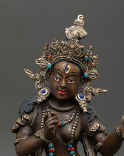Close up Mandarava dakini statue detail, serene face, handmade copper sculpture Patan Nepal, Vajrayana Buddhist spiritual art with silver plated finish