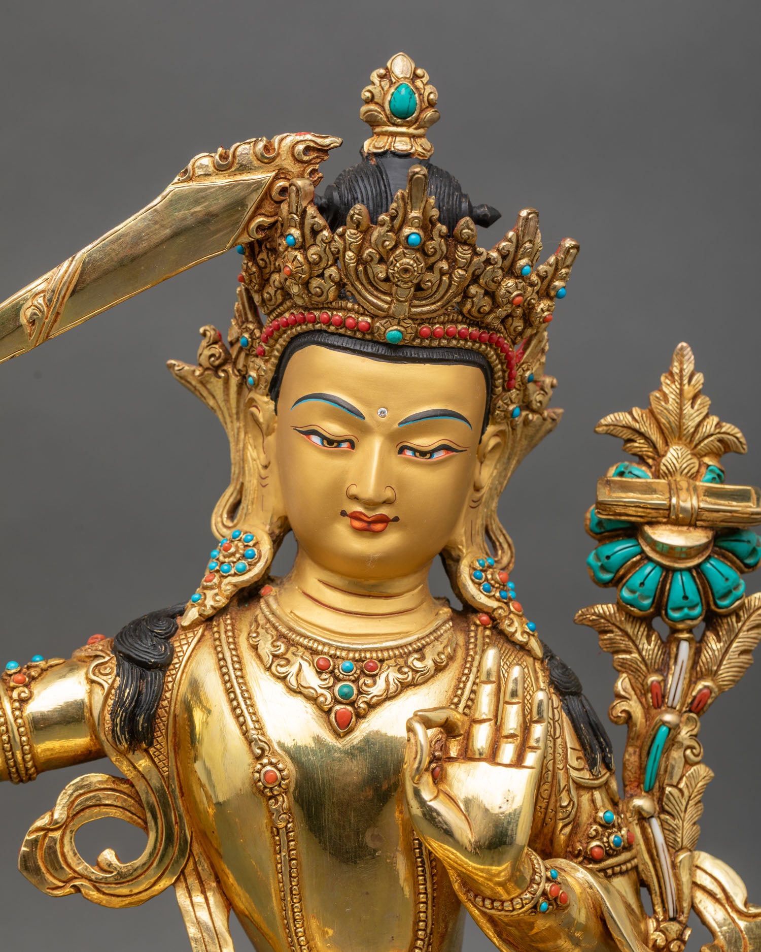 Close up Manjushree gold painted face wisdom sword lotus Prajnaparamita Sutra