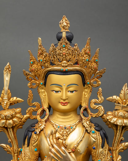 Close up Manjushree statue gold face detailed craftsmanship utpala flower wisdom sword Prajnaparamita scripture Himalayan Buddhist art Nepal