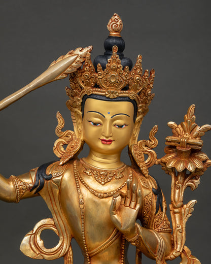 close up manjushri bodhisattva face gold painted expression detail nepal statue