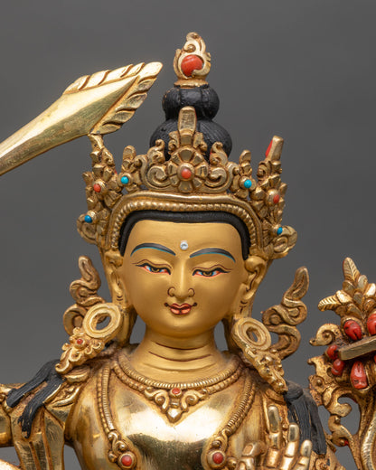 Close up Manjushri face serene gold-painted five-jewel crown detail