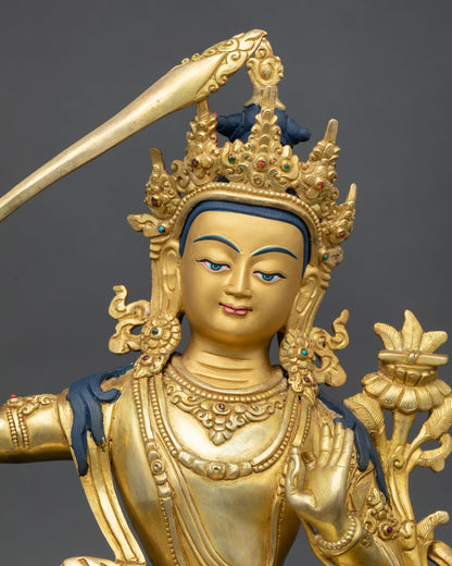 Close up Manjushri face with gold painted expression serene wisdom five jewel crown and detailed Newari artisan craftsmanship