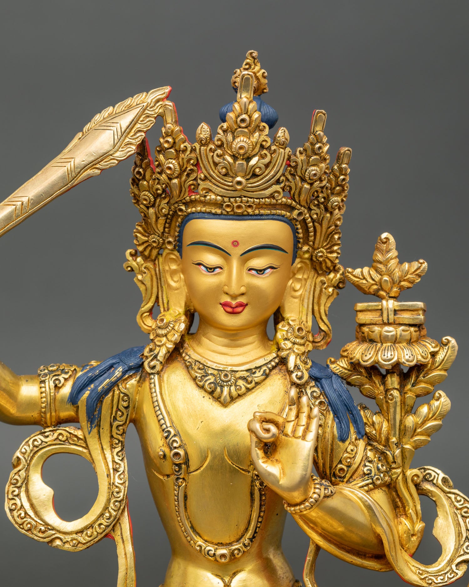Close up Manjushri statue serene face lotus pedestal Bodhisattva wisdom
