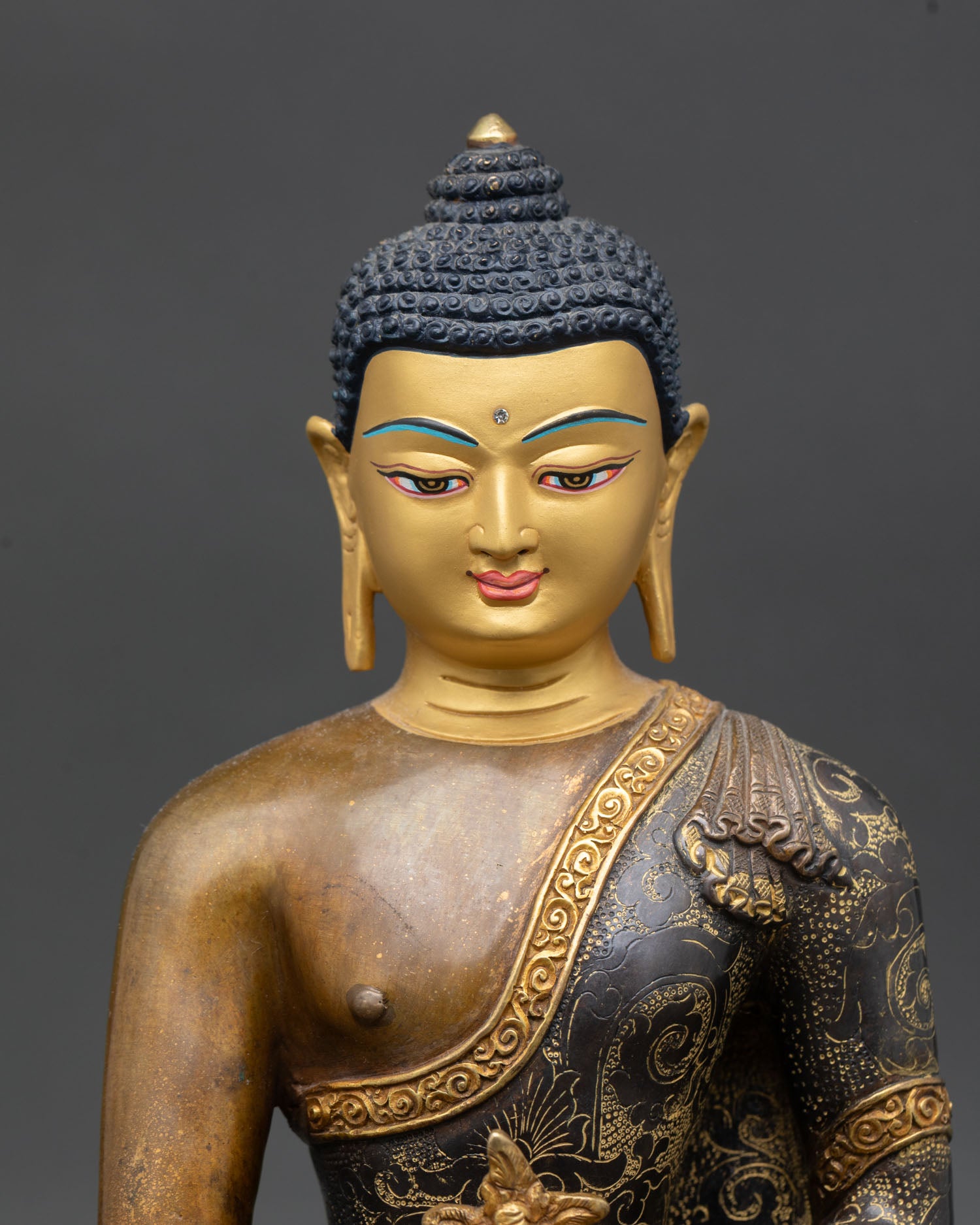 Close up Medicine Buddha face serene expression gold plated handmade Nepal