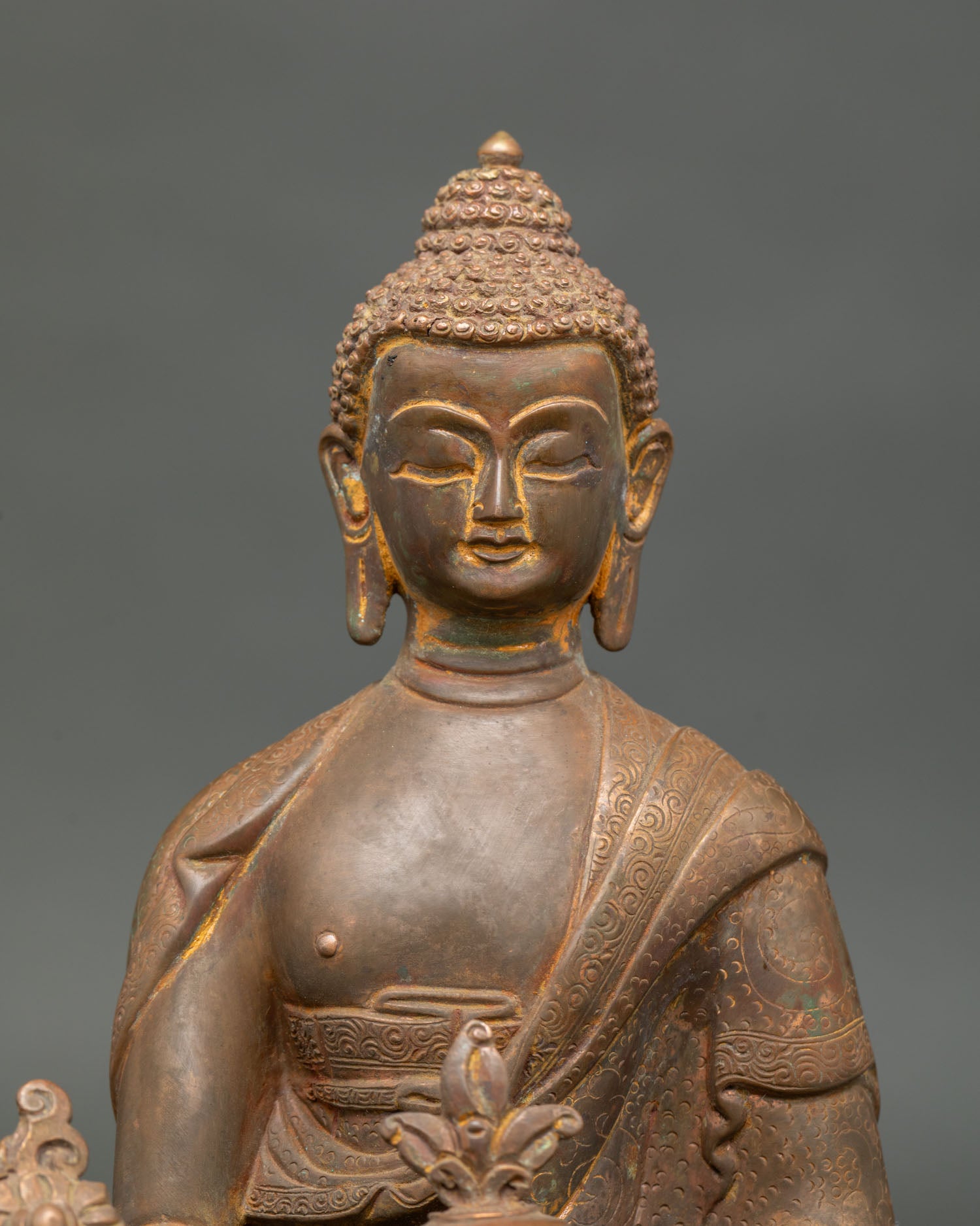 Close Up Medicine Buddha Face with Hand Carved Monk Robe Details.