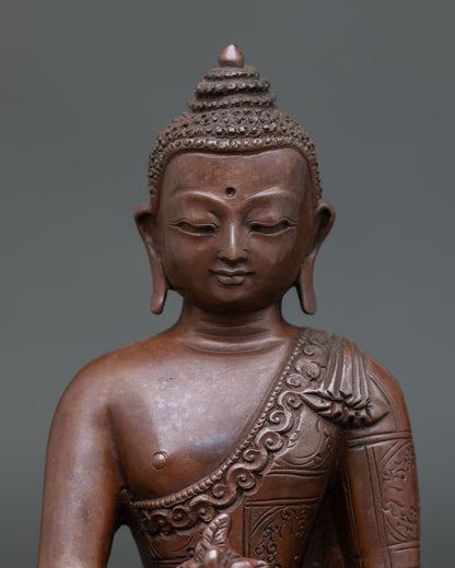 Close up Medicine Buddha statue detail floral robe carvings serene face Newari artisan craftsmanship copper sculpture