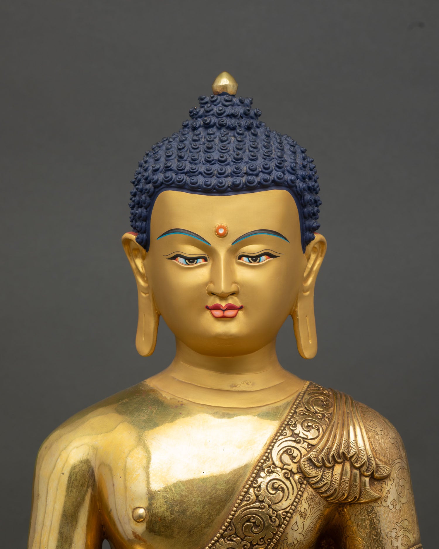 Close up Medicine Buddha statue gold gilded copper semi precious stone detailing Nepal