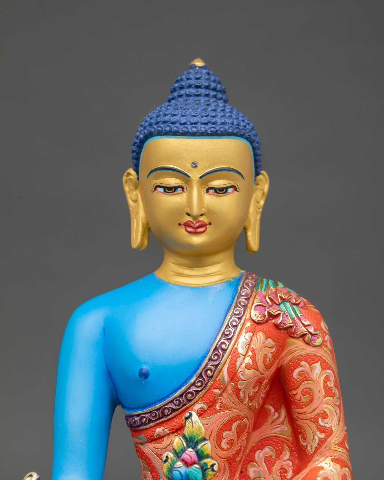 Close up Medicine Buddha statue with gold painted face hand applied acrylic details, Himalayan healing Buddha artwork