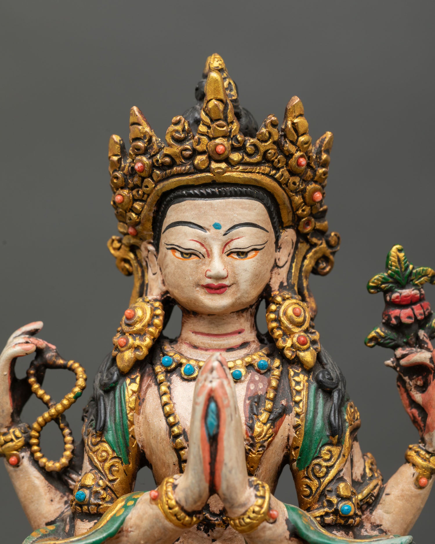 close up mini chenrezig statue copper handcrafted buddhist art with acrylic colors and stone inlay