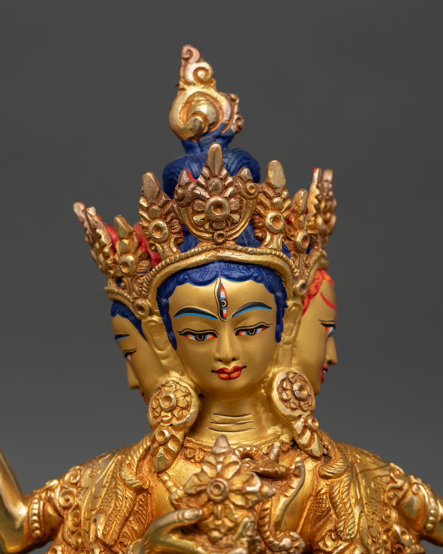Close up Namgyalma face three faces gold painted detail vishva dorje sacred symbols buddhist sculpture