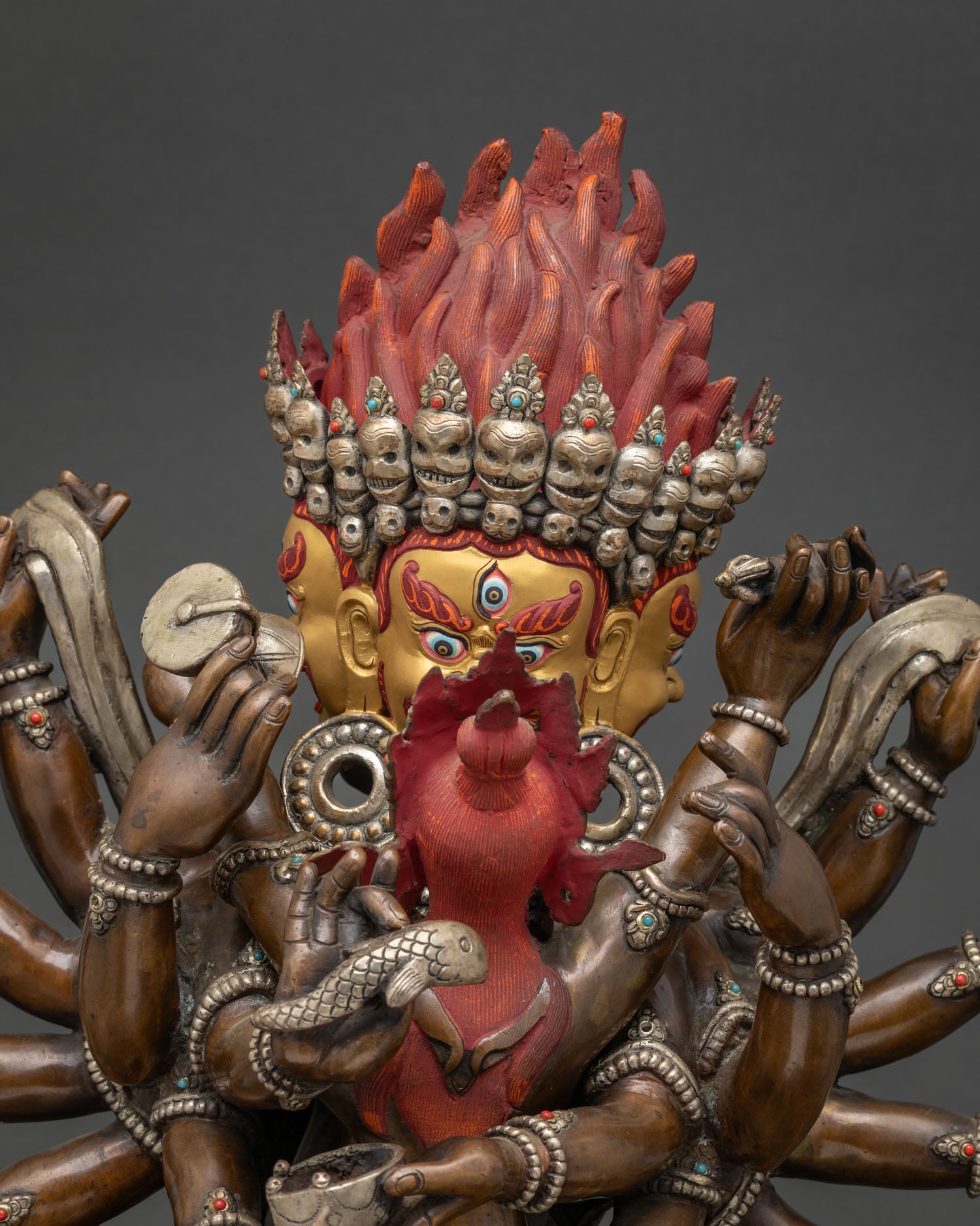 Close-up of 14-Armed Mahakala Yab-Yum oxidized copper statue with semi-precious stone inlay