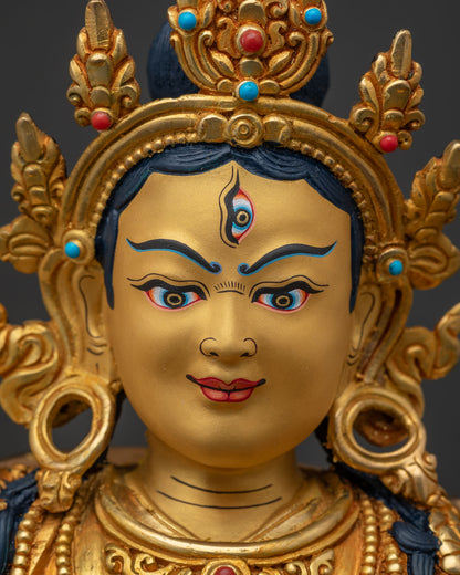 Close-up of Achi Chokyi Drolma's serene, gold-gilded face and crown
