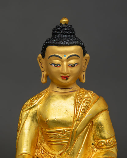 Close-up of Amitabha Buddha face with blue urna, black ushnisha and gold finish