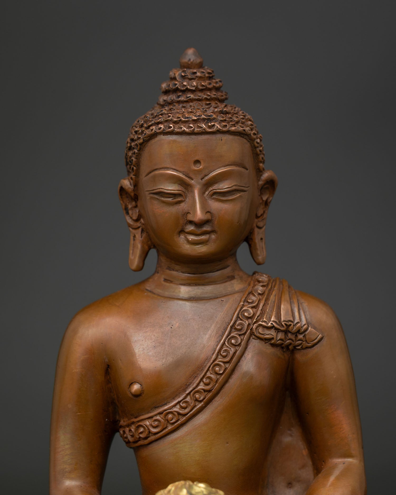 Close Up of Amitabha Buddha Face with Hand Carved Monk Robe Details.