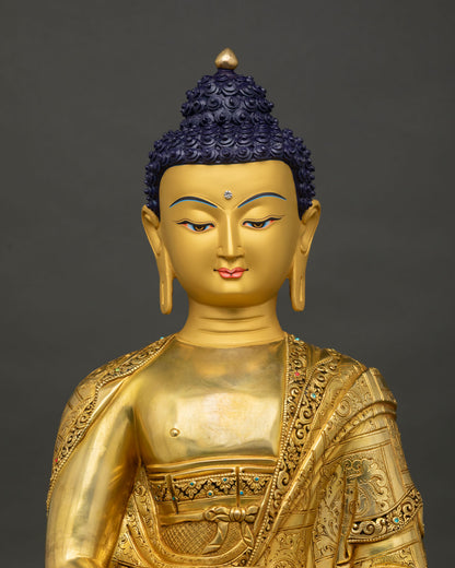 Close up of Amitabha Buddha statue showing serene gold painted face and intricate details