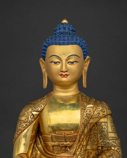 Close up of Amitabha Buddha's gold-painted face and hands in dhyana mudra