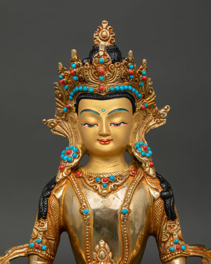 Close up of Amitayus Buddha face with gold painted details and turquoise coral stones.