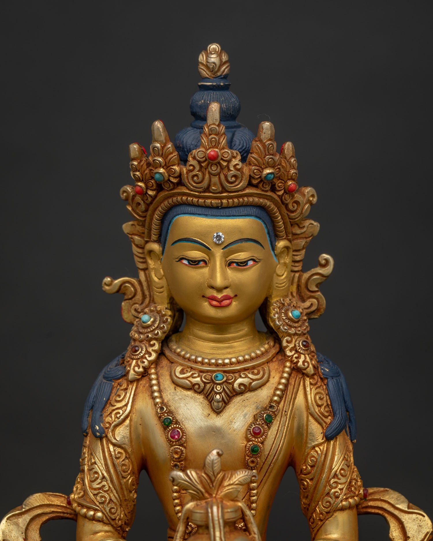 Close Up of Amitayus Gold Painted Face with Semi Precious Stones.