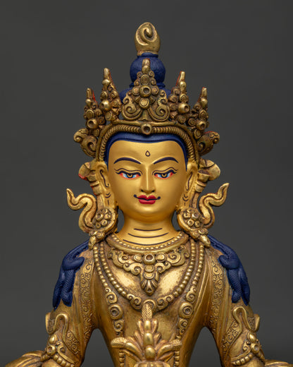 Close Up of Amitayus Gold Painted Face with Silk Robes and Dhyana Mudra Holding Tsebum.