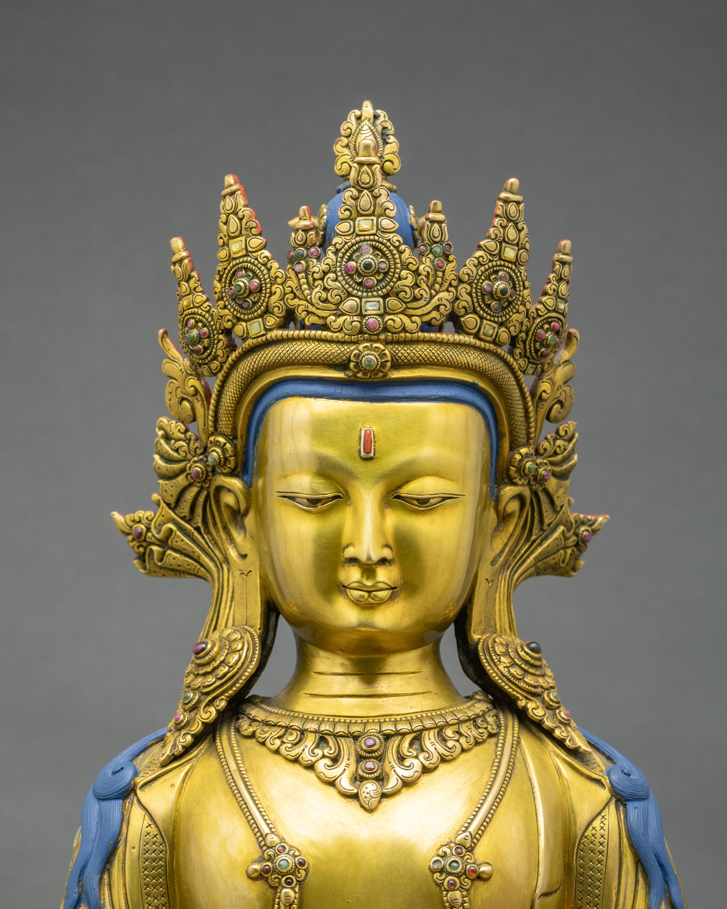 Close up of Amitayus statue showing fire gilded copper details, jeweled crown and amrita vase