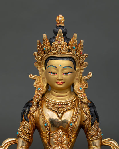 Close up of Amitayus Statue, showing gold painted face serene expression and intricate Nepalese Buddhist craftsmanship