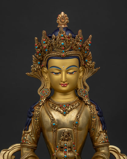 Close up of Amitayus with a gold painted face and semi precious stones.