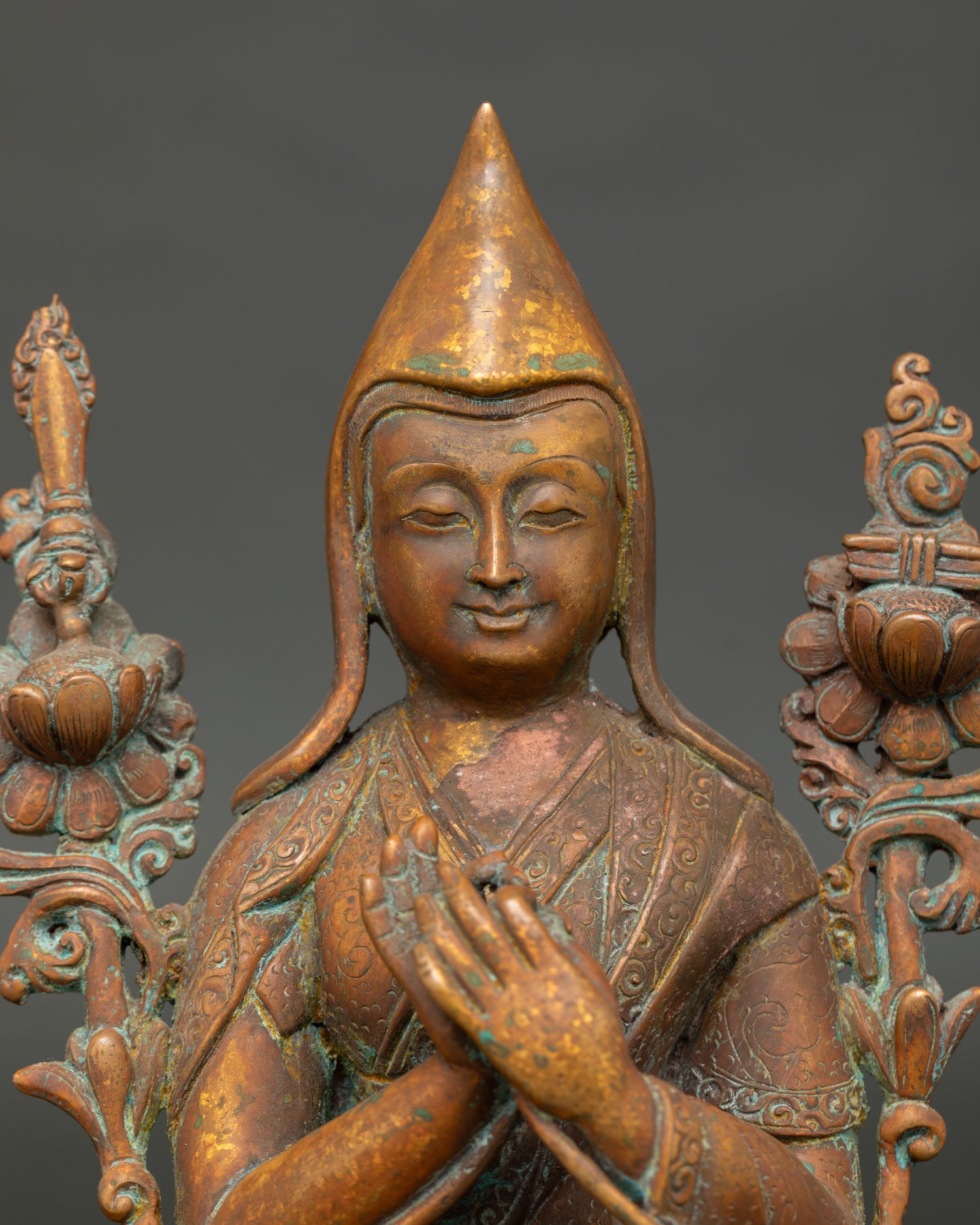 close up of antique finish tsongkhapa statue in oxidized copper