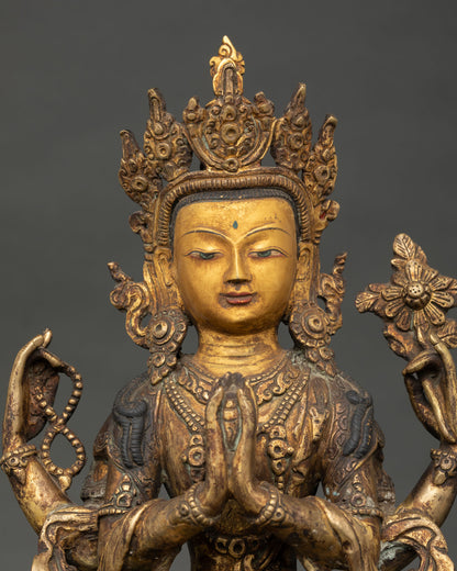 Close up of Avalokiteshvara statue face showing gold gilded details and compassionate expression