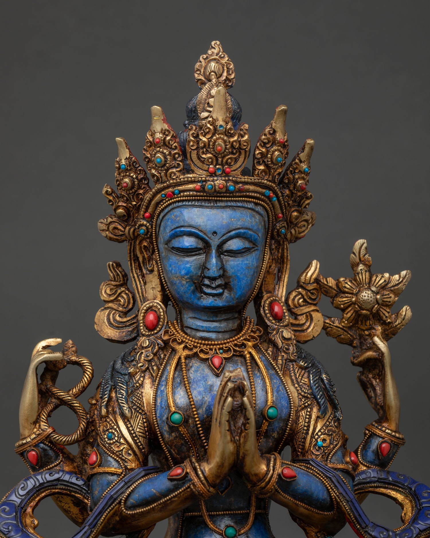 Close up of Avalokiteshvara statue with turquoise coral stones 