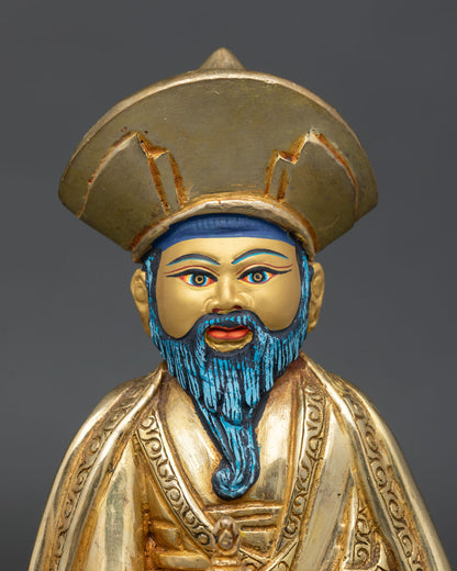 Close up of bearded lama face showing gold painted features traditional hat and detailed Nepalese craftsmanship