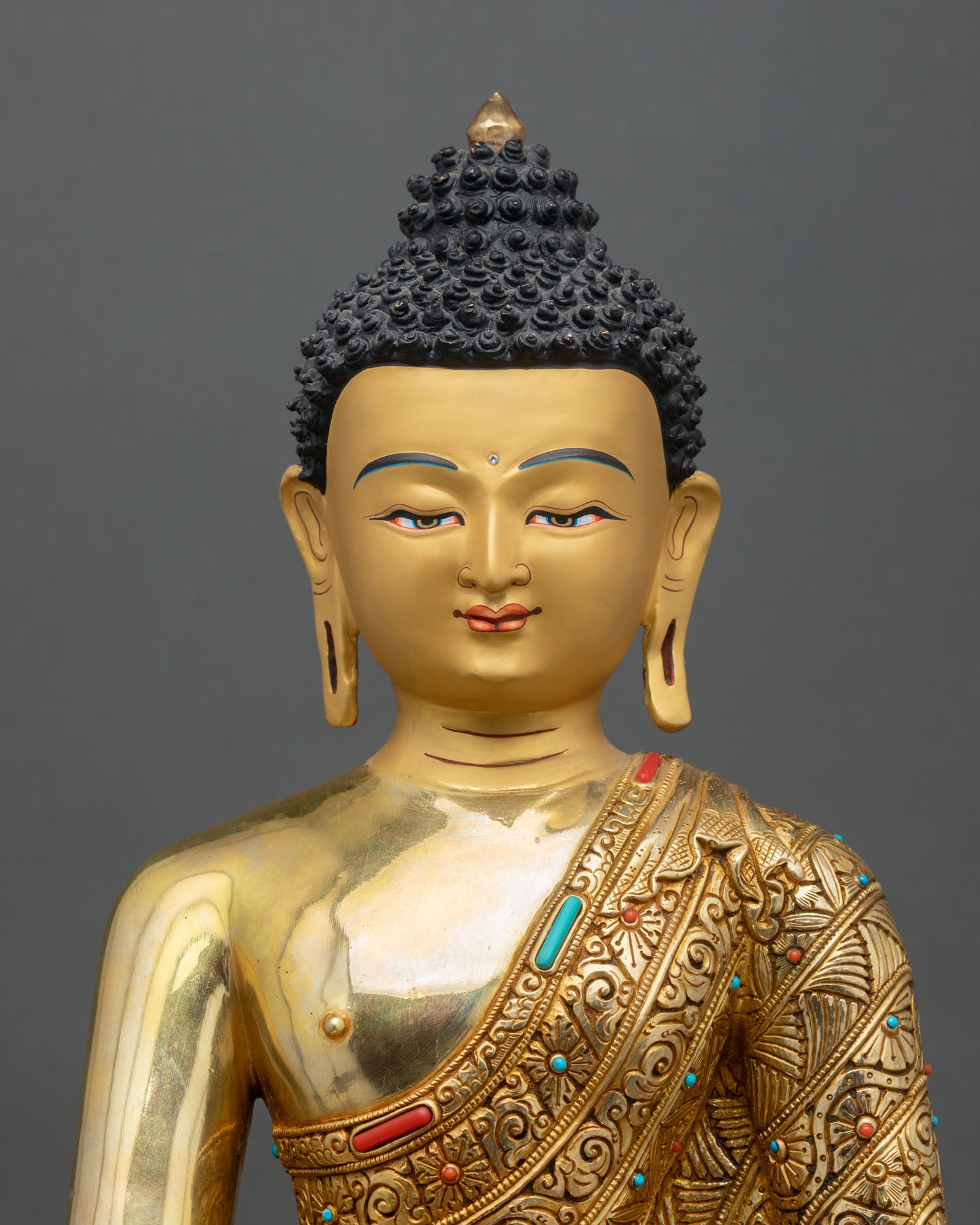 Close up of Bhaisajyaguru sculpture with floral robe and healing bowl