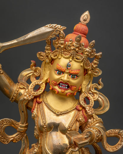 Close up of black manjushri 24k gold painted face and intricate traditional adornments.