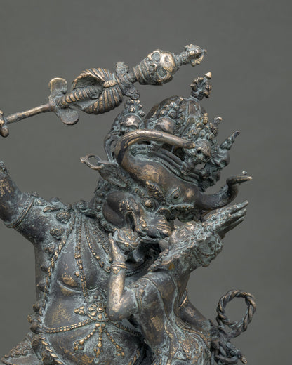 Close-up of bronze Yamantaka statue showing khatvanga staff, ornate garlands and Vajravetali consort