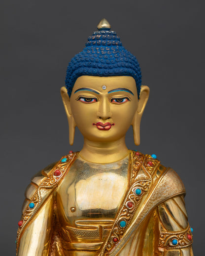 Close up of Buddha Shakyamuni featuring a serene gold-painted face 