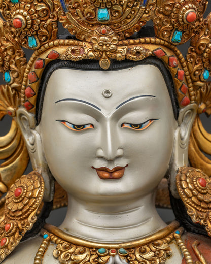 Close-up of Chenrezig statue's gold-gilded face and five-jeweled crown, Nepali craftsmanship