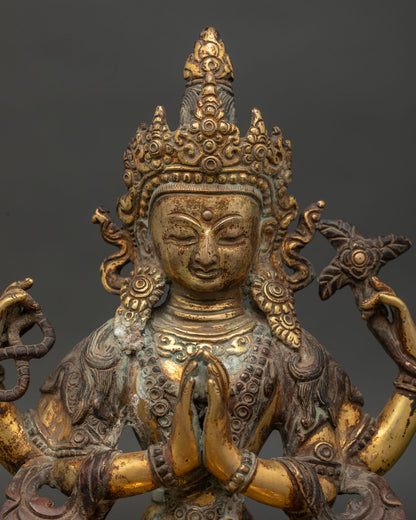 Close-up of Chenrezig Statue holding crystal rosary lotus flower and wish-fulfilling jewel.