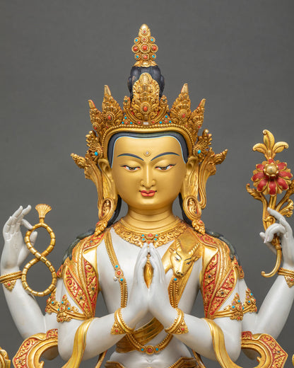 Close up of Chenrezig statue showing detailed robes, jewelry, and gold fire gilded finish