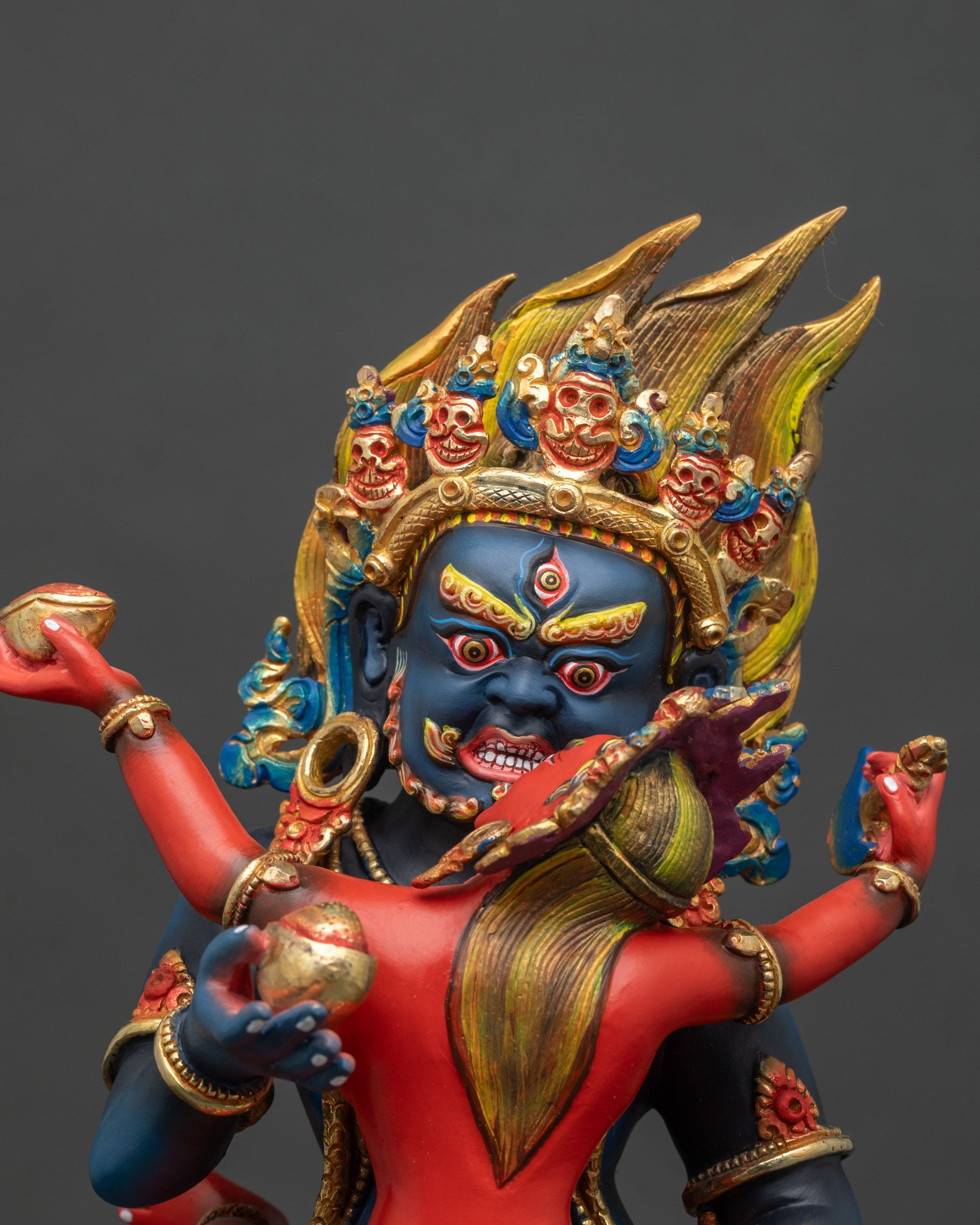 Close-up of colorful Black Dzambhala Yab Yum statue with intricate copper and acrylic details