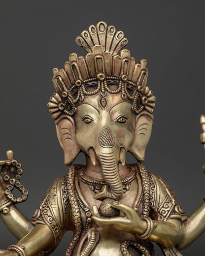 Close-up of copper Ganesh statue showing hand-chased carving and lotus throne detail